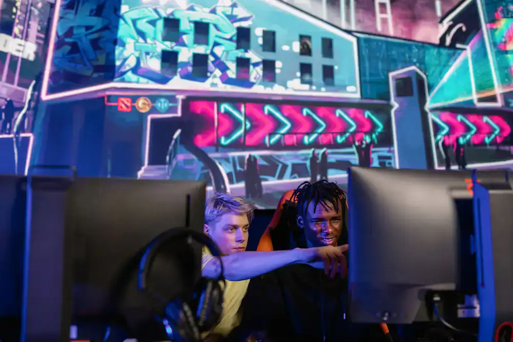 Two players studying frame data on a monitor
